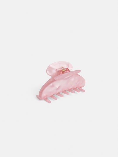 The Large Round Claw is a light pink, semi-translucent acetate hair accessory with interlocking teeth and a curved shape, shown on a plain white background.
