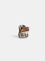 The Small Round Claw is a handcrafted brown and cream marble-patterned acetate hair clip with curved prongs, made in France and shown upright on a plain white background.