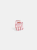 The Small Round Claw, a glossy pink acetate hair accessory with curved prongs, is shown standing upright on a plain white background.