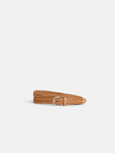The Dragon Diffusion Woven Leather Belt, tan and braided with a silver D-ring buckle, is coiled neatly on a plain white background.