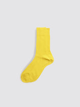 A single Maria La Rosa Bio Cotton Ribbed Sock in yellow is laid flat on a light gray background.