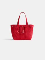 The Perfect Weekday Tote: a large red personalized bag with two handles, silver studs on the top edge, and "CHI" stitched in white on the front. Background is plain white.