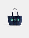 The Painted Perfect Weekday Tote is a spacious navy blue bag featuring two sets of handles and green-outlined "MSD" letters on the front, shown against a plain white background.