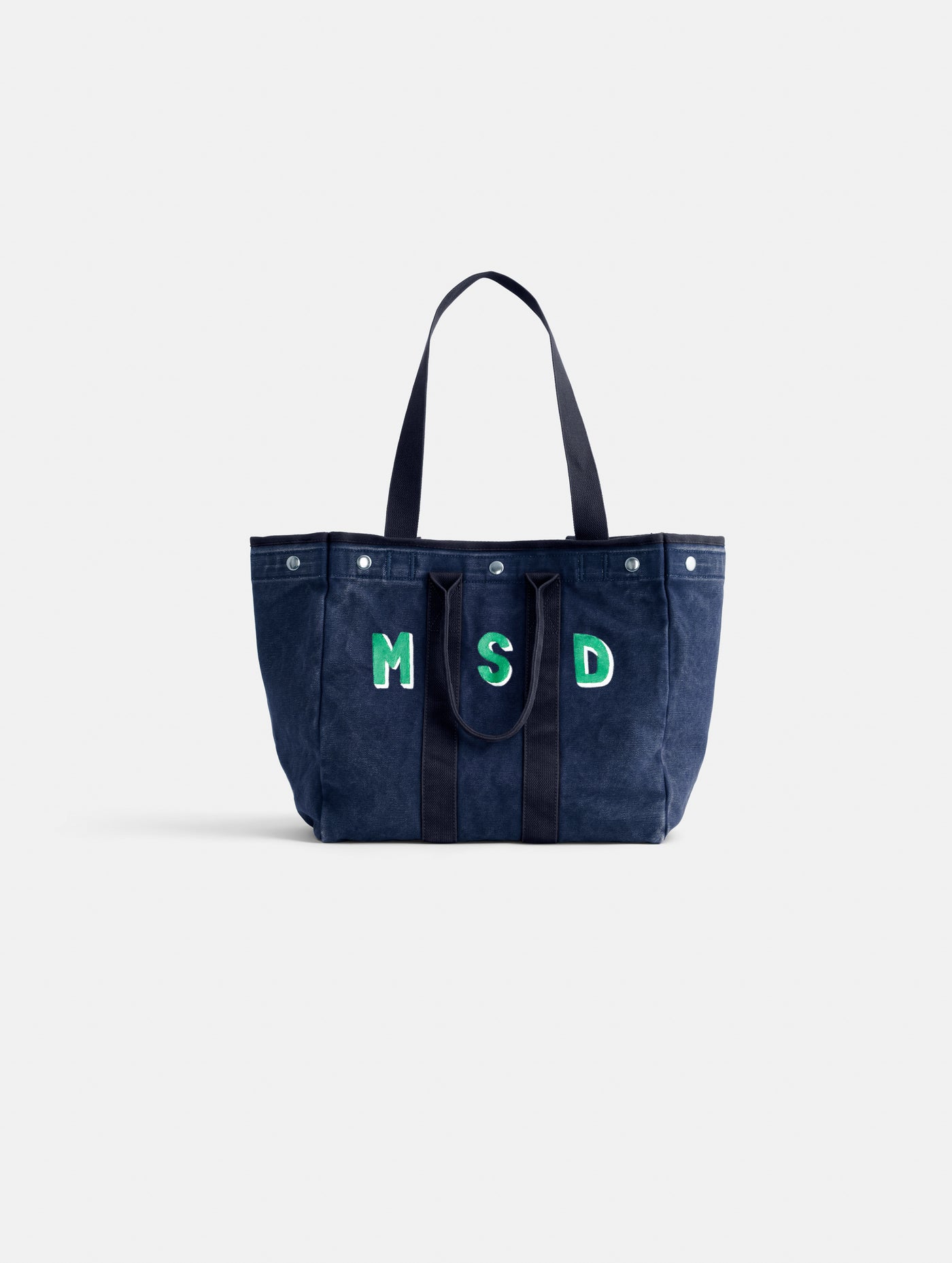 The Painted Perfect Weekday Tote is a spacious navy blue bag featuring two sets of handles and green-outlined 