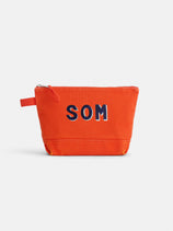 The Perfect Canvas Pouch is a bright orange zippered bag with a side tab and bold navy blue and white "SOM" letters on the front. Set against a plain white background, it’s ideal for use as a personalized pouch or makeup bag.
