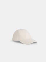 The Washed Canvas Baseball Cap in light beige features a curved brim, stitched eyelets, and an adjustable back strap, shown against a white background.