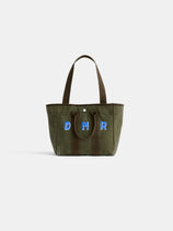 The Perfect Daily Tote: a green cotton bag with brown handles, showcasing DMR initials in blue and white on the front. Photographed against a plain white background, this chic tote is ideal for everyday use.