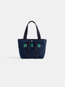 The Painted Perfect Daily Tote is a navy blue bag with two handles, featuring the initials MSD in green and white on the front, shown against a plain white background.
