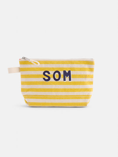 The Perfect Canvas Pouch in Stripe features horizontal yellow and white stripes, a white zipper, and bold dark blue SOM letters on the front—ideal as a personalized pouch or makeup bag.