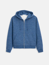 The 12th Street Zip Hoodie In Heather Fleece is a blue, relaxed-fit hoodie with a zip front, hood, spacious pockets, and long sleeves, crafted from heather yarn fleece and shown against a white background.