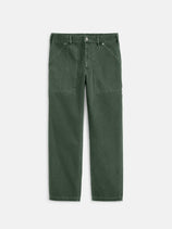 The Painter Pant In Recycled Denim features a relaxed fit in dark green, with front patch pockets, belt loops, and a button closure, shown laid flat on a white background.