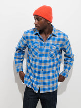 A person wearing a blue and cream plaid Cyrus Shirt in Flannel and an orange beanie.