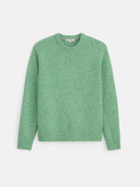 A Donegal Crewneck Sweater in light green with long sleeves is laid flat against a white background. The sweater showcases ribbed detailing on the collar, cuffs, and hem, along with a subtle speckled texture throughout. Crafted from a comfortable alpaca blend, this sweater provides both warmth and timeless style for any occasion.