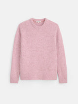 The Donegal Crewneck Sweater, shown in light pink and crafted from a soft alpaca blend, features long sleeves with ribbed cuffs, hem, and neckline. It is displayed flat against a plain white background.