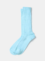 A pair of RoToTo Linen Cotton Ribbed Crew Socks in light blue, made with sustainable yarns, laid flat on a white background.