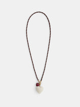 The Roxanne Assoulin Long Happy Cord Charm Necklace features a puffy white heart-shaped pendant, a smaller red heart charm near the clasp, and colorful dark brown cording.