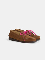 The Tampa Boat Shoe Sister is a brown suede moccasin-style loafer inspired by Italian boat shoes, featuring visible stitching and bright pink shoelaces, displayed against a plain white background.