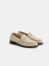 The New York Loafer Sister In Suede features beige handsewn suede uppers, brown soles, and low heels, shown on a white background.