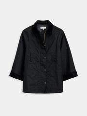 The Chiltern Street Jacket in waxed cotton is black, features a collar, two front pockets, three-quarter sleeves, and is water-repellent. Displayed on a plain white background.