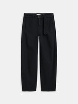 The 9th Street Pant is a black, high-waisted women’s style made from 100% cotton with a matching fabric belt, straight-tapered legs, side pockets, and belt loops. Shown against a plain white background.